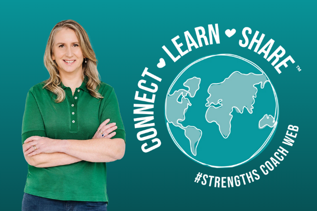 woman in a green shirt standing next to the Connect Learn Share globe logo